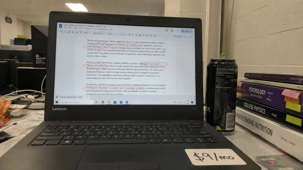 Rytr budget AI writing tool showing a draft with revision marks on an older laptop screen