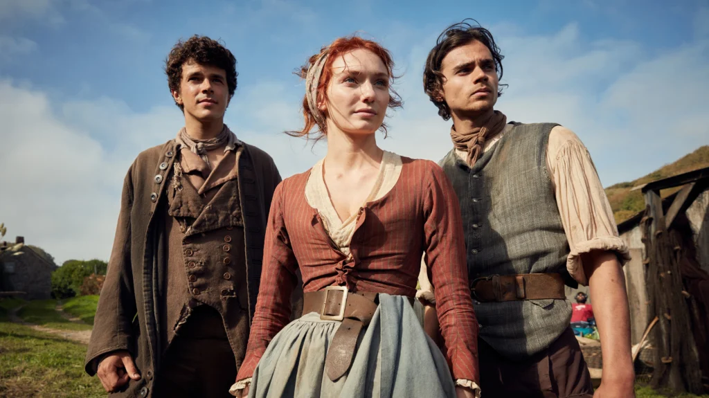 Aidan Turner as Ross Poldark standing on the Cornwall cliffs